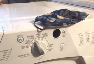 face mask on top of washing machine