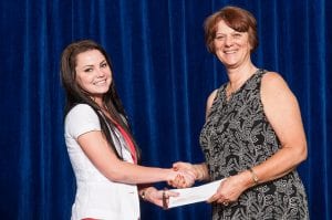 Adrienne Adams receiving a scholarship from Glenna Urbshadt