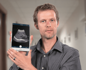 Kris Dickie, Vice President, Research and Development at Clarius Mobile Health holds a wireless handheld ultrasound device developed by his team.