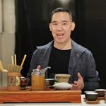 Matt Chong smiles in front of tea tasting display
