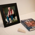 A framed photo of a male in his 60s sits on a white table in the BCIT mining lab. 