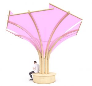 An artificial tree with a wood base and pink shades as trees. A man is sitting on the base of the tree.