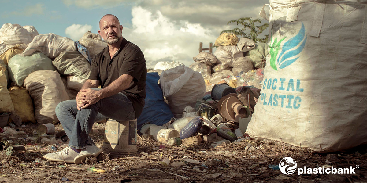 Plastic Bank CEO and Chair David Katz sitting among plastic pollution