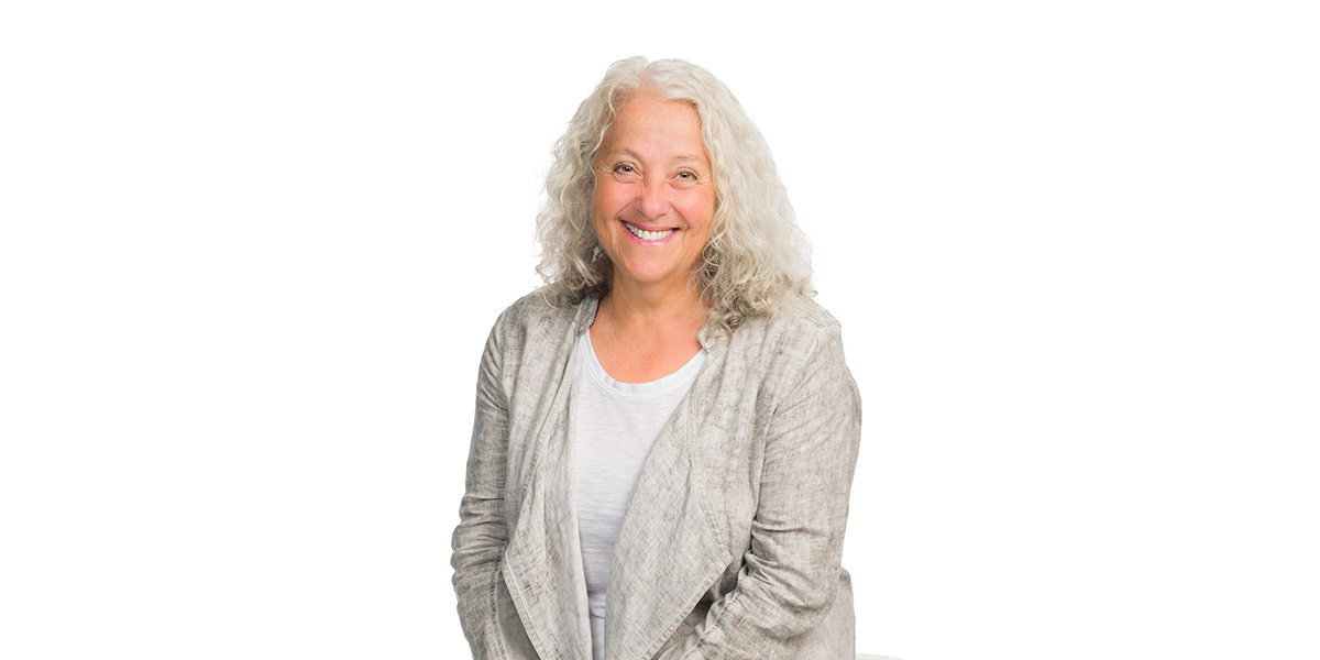 BCIT alumna Dr Judy Shandler smiles against a white backdrop