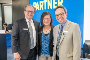 Three people dressed in business attire smile for a photo. Pictured from left to right: BCIT Alumni Association President Emil Bosnjak, Dr. Candy Ho, and Kenton Low.