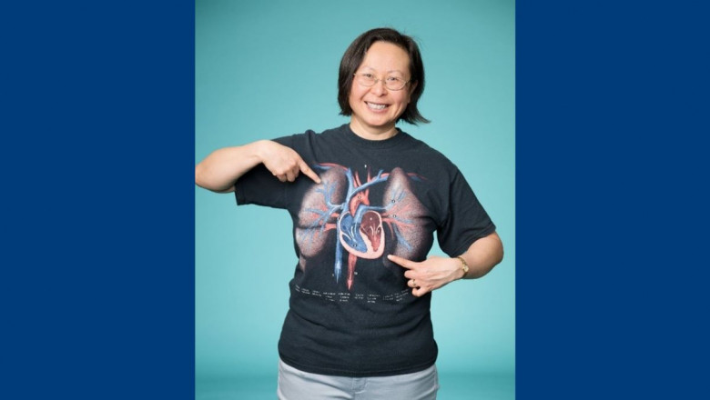Dr. Jennifer Kong pointing to her heart diagram t-shirt.