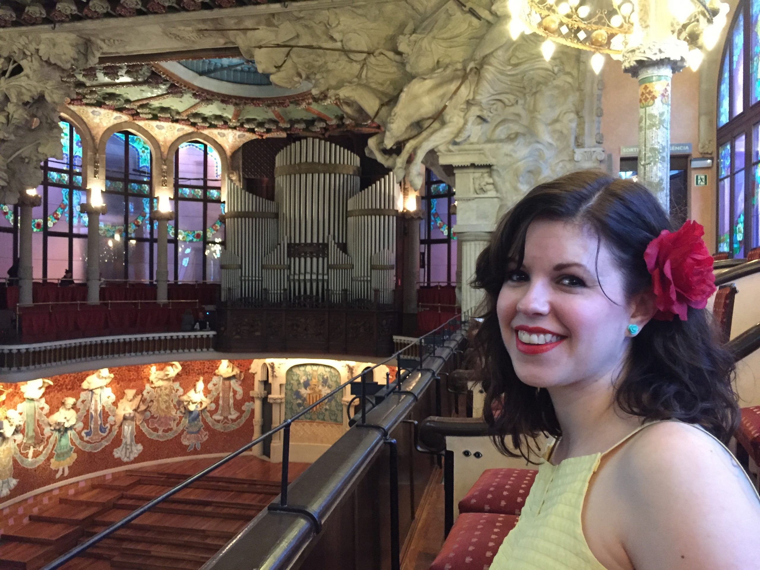 Julie in a theatre with a red flower in her hair.