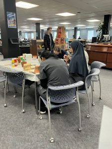 students sitting at a table in the library