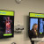 female presenter stands in front of a screen that shows medical scans with the title "PET SCANS - PET/CT & BC Cancer"